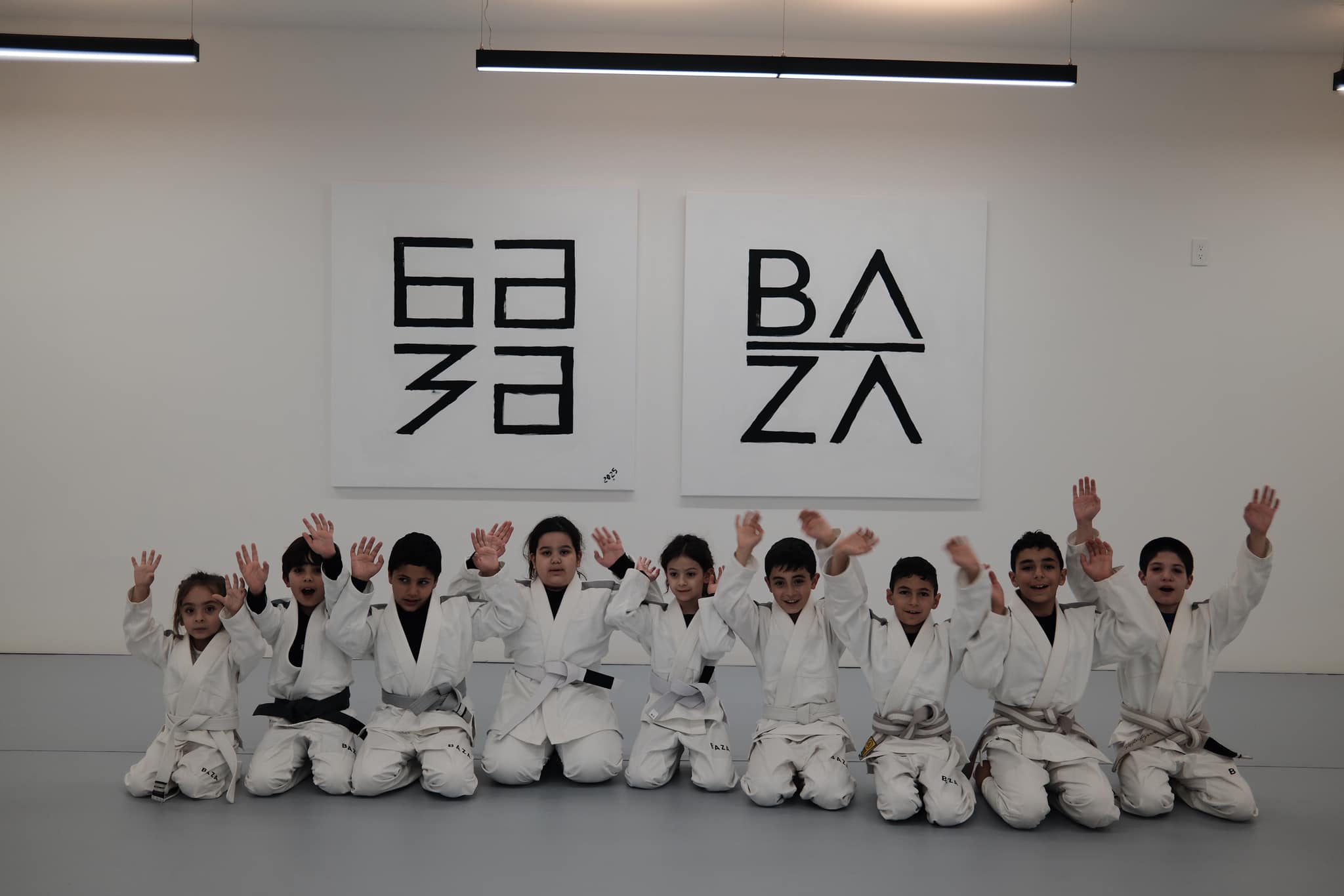 Focused young student in BAZA gi during youth BJJ class